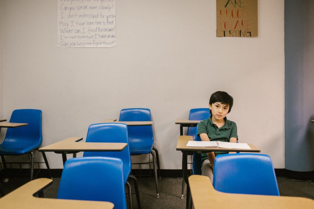 Boy alone in a classroom