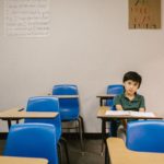 Boy alone in a classroom